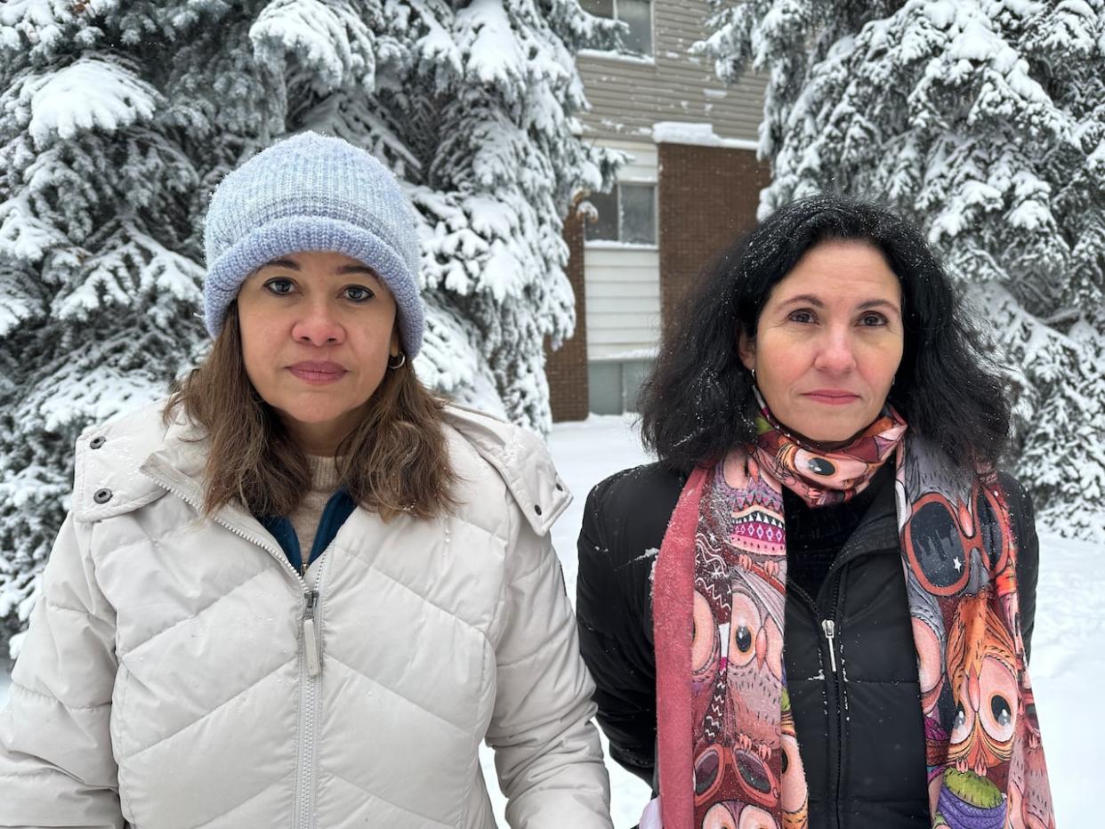 Carla Ferret, left, and Yamilé López, right, had to evacuate their apartment building in February due to high carbon monoxide levels. López is now calling for carbon monoxide alarms to be made mandatory for all residences in Alberta. (Madeleine Cummings/CBC - image credit)