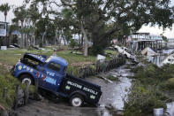 FILE - Pick up trucks and debris lie strewn in a canal in Horseshoe Beach, Fla., after the passage of Hurricane Idalia, Wednesday, Aug. 30, 2023. Category 5 status — when sustained winds are at least 157 mph or 253 kph — is quite rare. Only about 4.5% of named storms in the Atlantic Ocean have grown to a category 5 in the past decade, said Brian McNoldy, a scientist and hurricane researcher at the University of Miami. (AP Photo/Rebecca Blackwell, File)