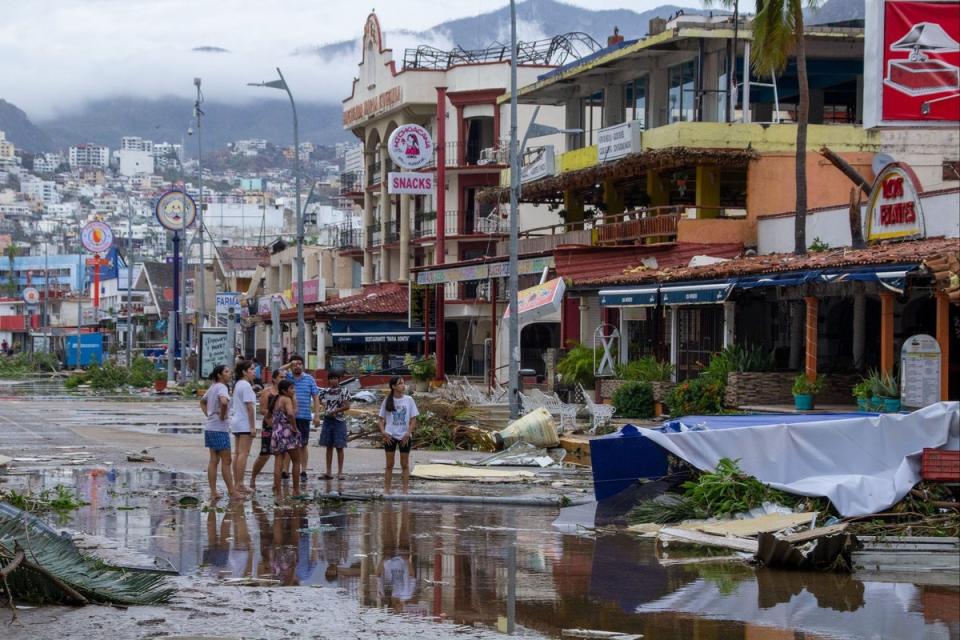 Residents look at debris in the streets (Getty Images)