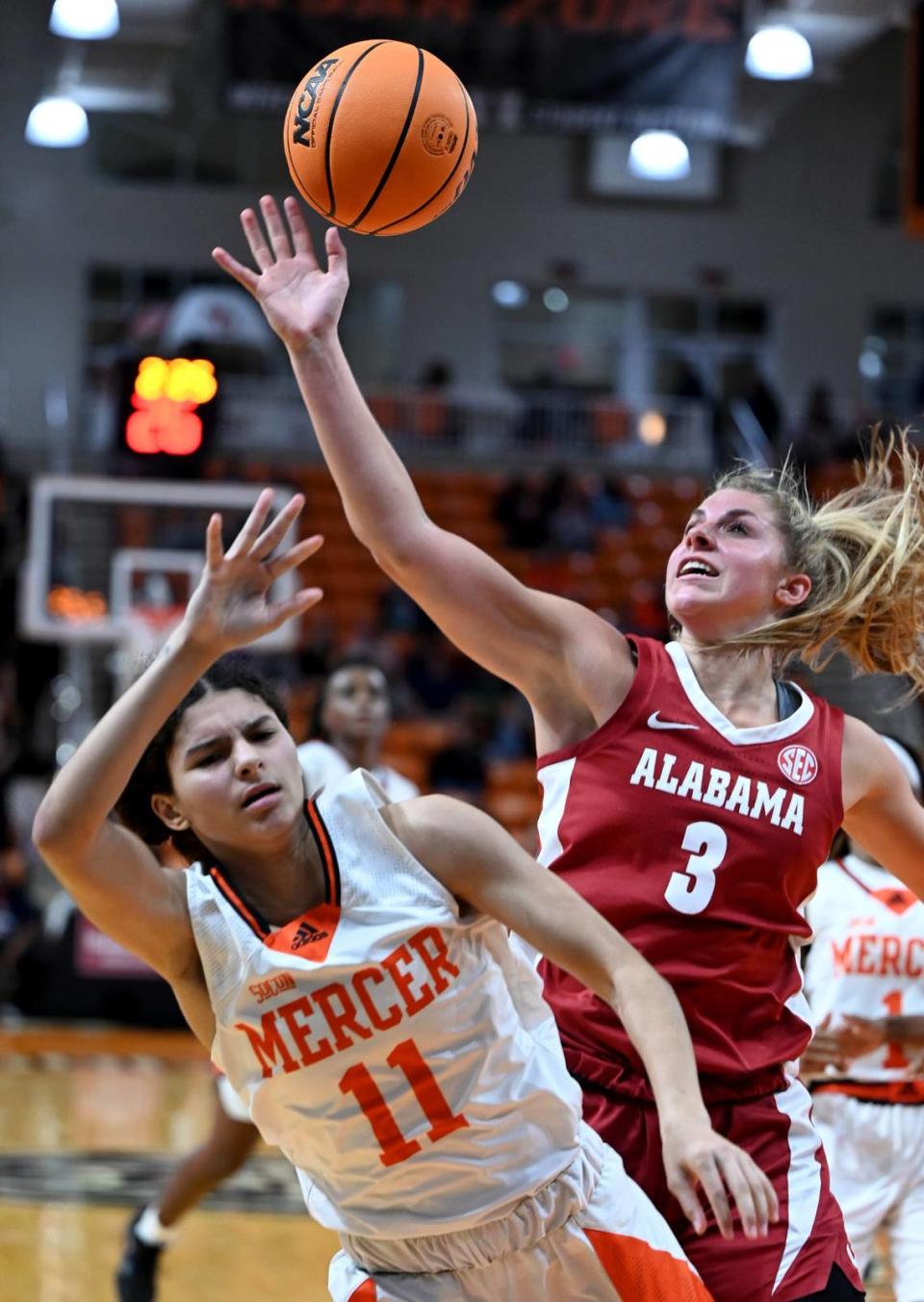 Mercer guard Enjulina Gonzalez (11) is fouled by Alabama guard Sarah Ashlee Barker (3) during their game Nov. 30.