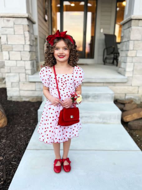 PHOTO: Austyn wore a white dress decorated with red hearts, a red bow headband, and matching red shoes to the Valentine's Day daddy-daughter dance on Feb. 8. (Courtesy of Kelsey Woolverton)