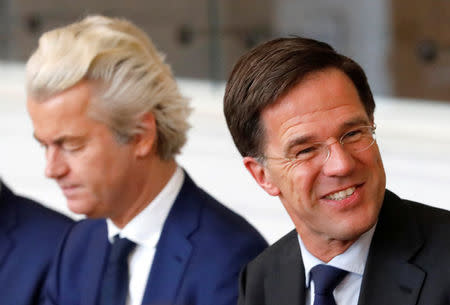 FILE PHOTO: Dutch Prime Minister Mark Rutte (R) of the VVD Liberal party and Dutch far-right politician Geert Wilders of the PVV Party take part in a meeting at the Dutch Parliament after the general election in The Hague, Netherlands, March 16, 2017. REUTERS/Yves Herman/File Photo