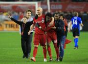 <p>Michael Bradley #4 of Toronto FC celebrates with Tosaint Ricketts #87 at the final whistle following the MLS Eastern Conference Final, Leg 2 game against Montreal Impact at BMO Field on November 30, 2016 in Toronto, Ontario, Canada. (Photo by Vaughn Ridley/Getty Images) </p>