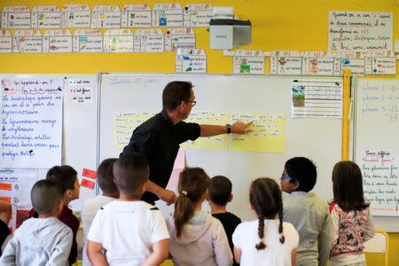 School children listen to their teacher Sebastien Ducoroy in their classroom at the Primary School Les Ormeaux in Montereau-Fault-Yonne near Paris, France, June 18, 2018. REUTERS/Gonzalo Fuentes/Files