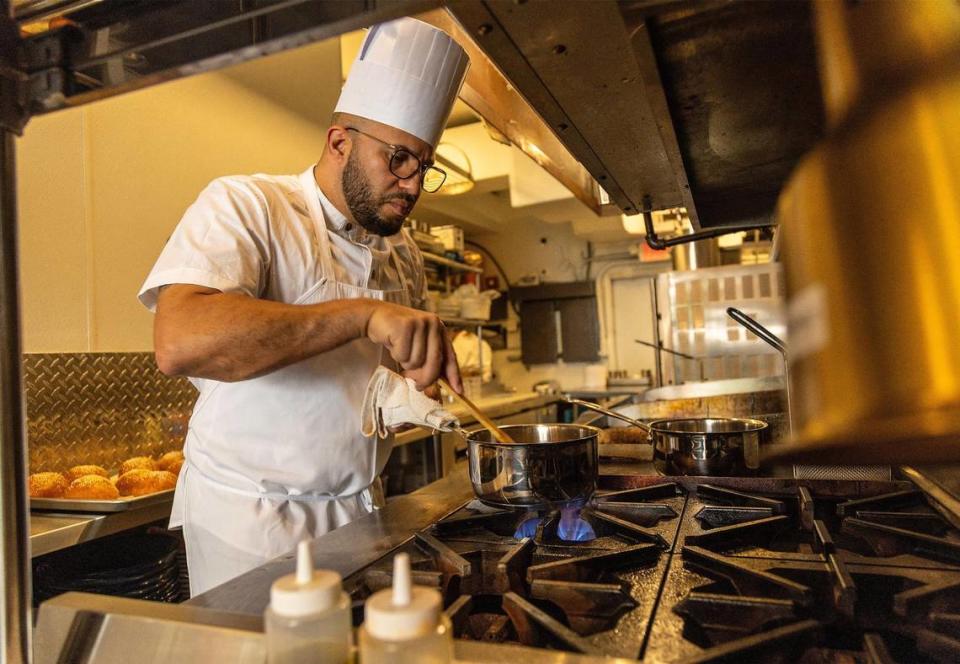 Chef Nuno Grullon prepares a chicken pot pie in the kitchen of his new restaurant Grand Central.