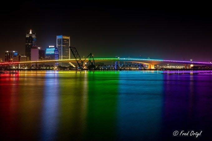 Rainbow lighting reflects off the St. Johns River where the Jacksonville Transportation Authority lit up the Acosta Bridge in downtown Jacksonville during Pride month. The Pride lighting won't happen this June because the state Department of Transportation decided only red, white and blue lighting will happen on state bridges from Memorial Day to Labor Day.