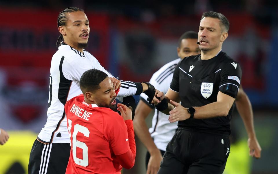 Leroy Sane of Germany clashes with Phillipp Mwene of Austria leading to a red card