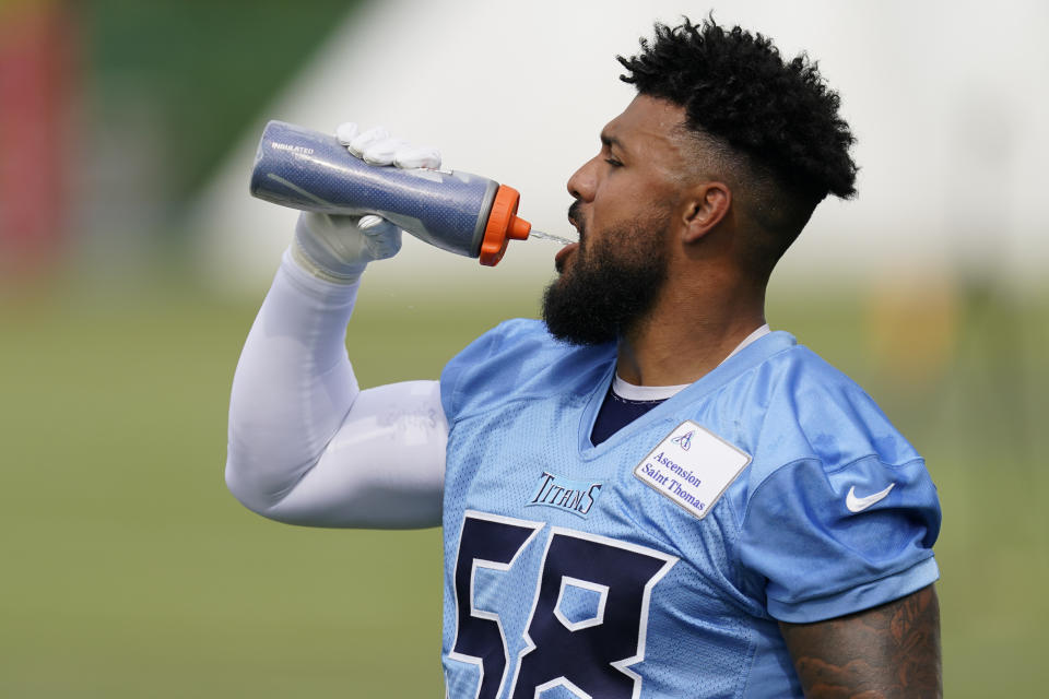 Tennessee Titans outside linebacker Harold Landry III takes a drink during an NFL football training camp practice Wednesday, July 26, 2023, in Nashville, Tenn. (AP Photo/George Walker IV)