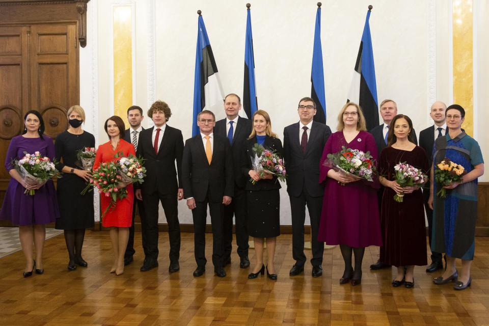 The new appointed Estonian Prime Minister Kaja Kallas, center, poses for a photo with a new cabinet members in Tallinn, Estonia, Tuesday, Jan. 26, 2021. Estonia's new two-party coalition government has been sworn in with the first female prime minister since the Baltic country regained independence in 1991. The 15-member Cabinet of Prime Minister Kaja Kallas, a 43-year-old lawyer and a former European Parliament lawmaker, was approved Tuesday in the 101-seat Riigikogu legislature. (AP Photo/Raul Mee)