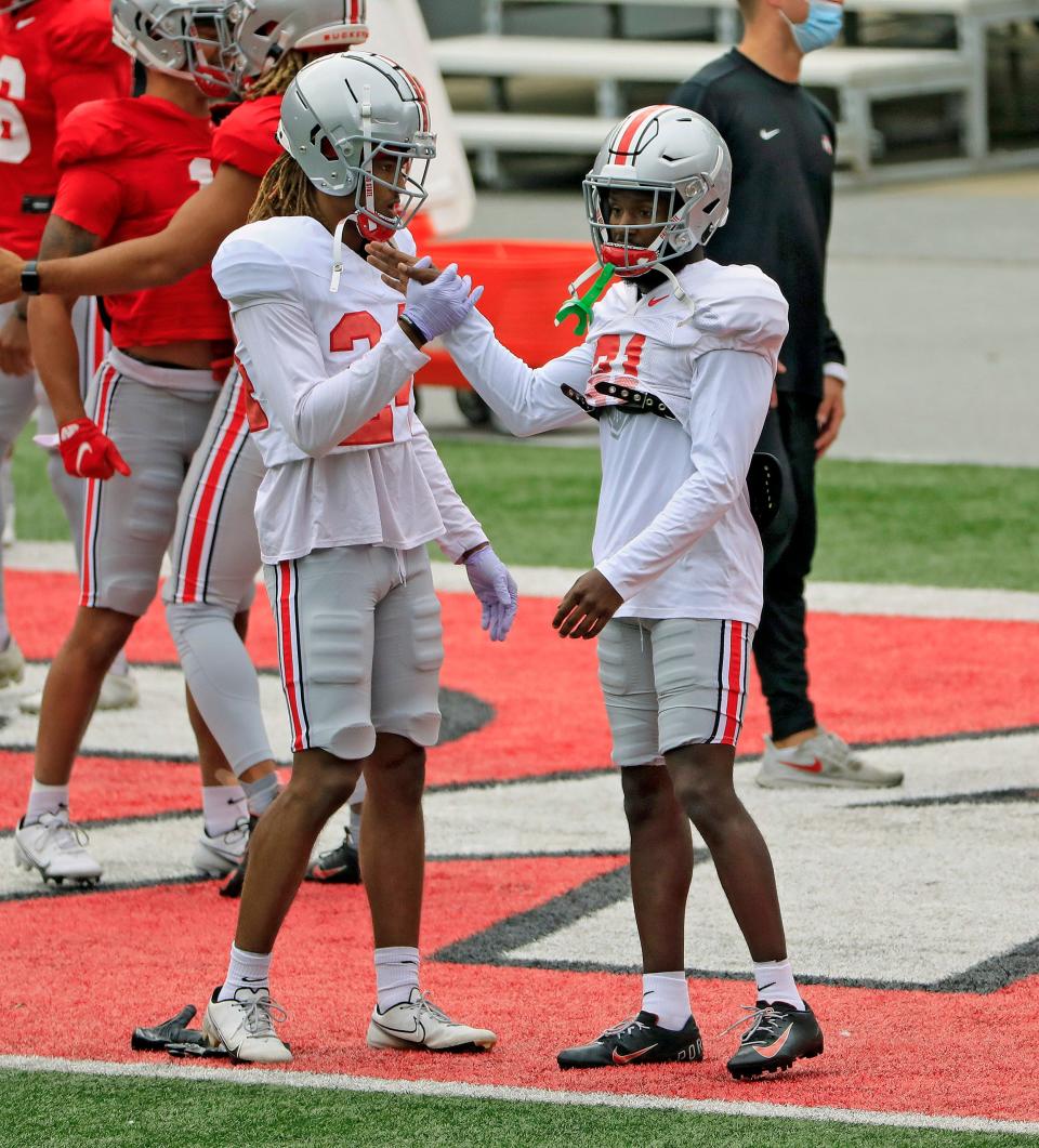 Ohio State Buckeyes cornerback Shaun Wade (24) and Ohio State Buckeyes cornerback Marcus Williamson (21) high-five after stretching while warming up during practice at Ohio Stadium in Columbus, Ohio on October 3, 2020. 