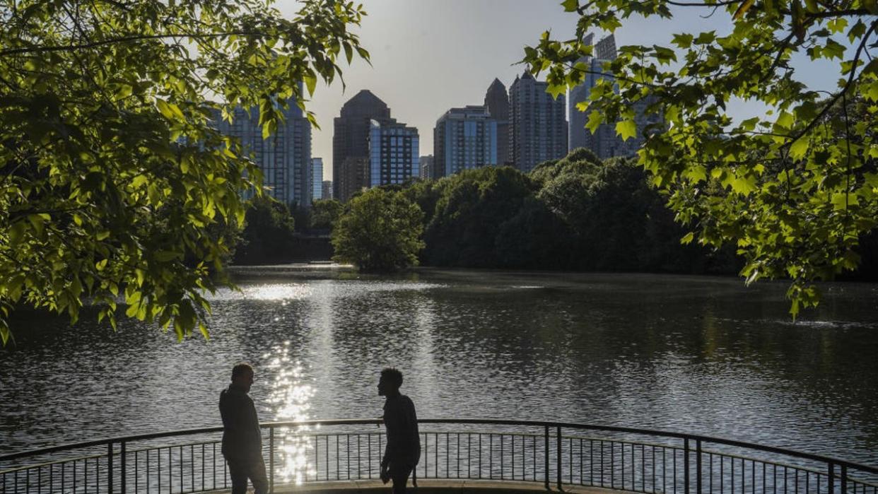 <div>Men enjoy the view as the sun sets at Piedmont park in Atlanta. (Photo by Camilo Freedman/SOPA Images/LightRocket via Getty Images)</div>