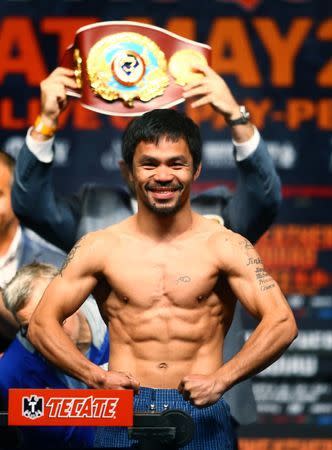 May 1, 2015; Las Vegas, NV, USA; Manny Pacquiao flexes during weigh-ins for the upcoming boxing fight against Floyd Mayweather (not pictured) at MGM Grand Garden Arena. Mandatory Credit: Mark J. Rebilas-USA TODAY Sports