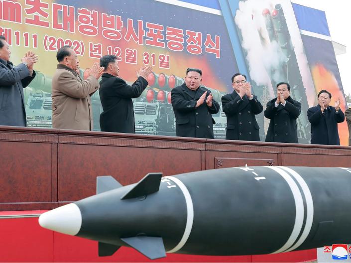 In this photo provided by the North Korean government, North Korean leader Kim Jong Un, center, attends a ceremony of donating 600mm super-large multiple launch rocket system at a garden of the Workers' Party of Korea headquarters in Pyongyang, North Korea Saturday, Dec. 31, 2022.