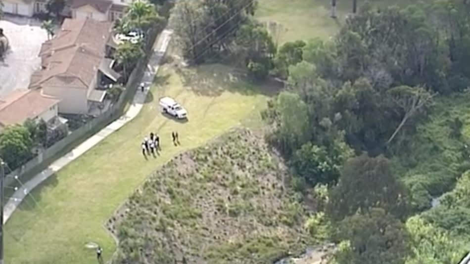 Aerial shot of Queensland Police in bushland near Slacks Creek, south of Brisbane. 