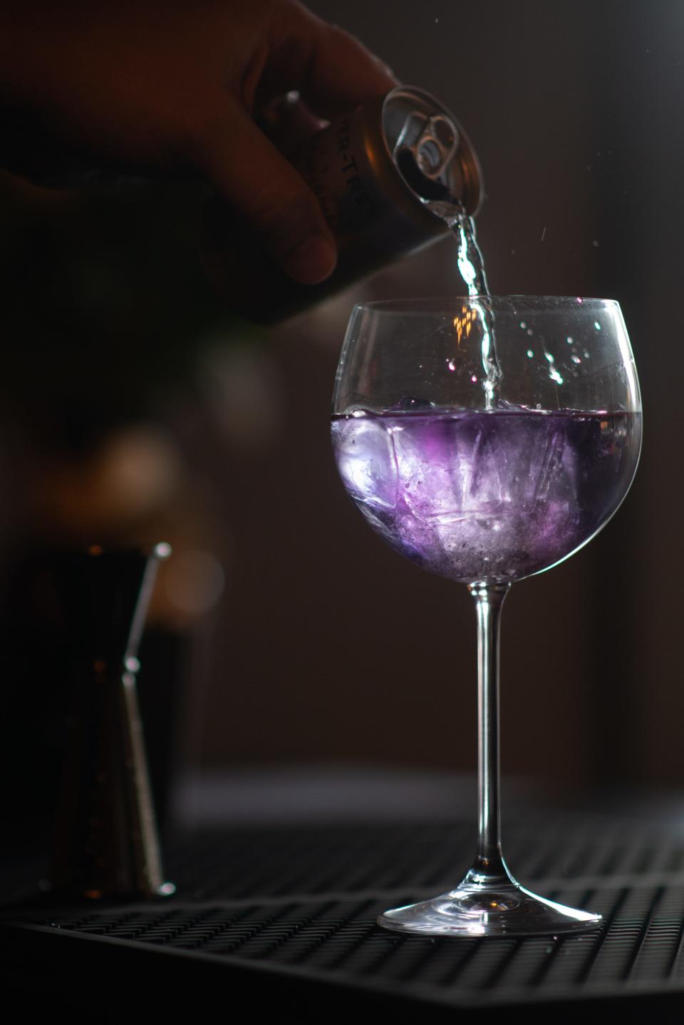 A cocktail called Indigo Mist, a drink similar to a gin and tonic, is mixed by Salut  co-owner Marc Sonderegger.