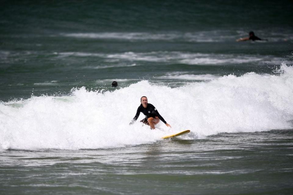 A surfer riding a white-cresting wave.