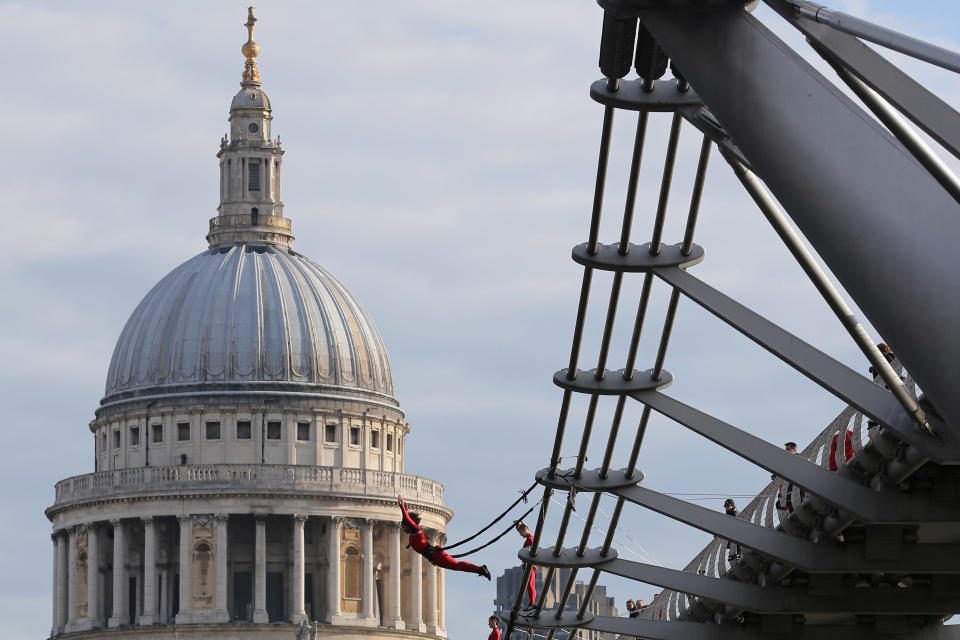 LONDON, ENGLAND - JULY 15: Dancers bungee off the Millennium Bridge as part of the 'One Extraordinary Day' performances on July 15, 2012 in London, England. The dancers are part of American choreographer Elizabeth Streb's 'extreem action' dance group which will perform around London for one day only and form part of the Cultural Olympiad. (Photo by Dan Kitwood/Getty Images)