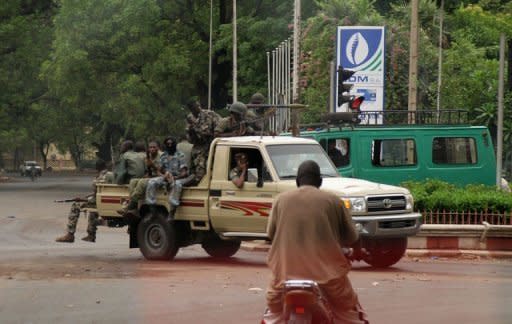 Soldiers drive around a roundabout in central Bamako. Rebel soldiers who took control of Mali in March said they had defeated an attempt to kill coup leader Captain Amadou Haya Sanogo, but insisted that the turmoil would not affect the rule by an interim civilian government