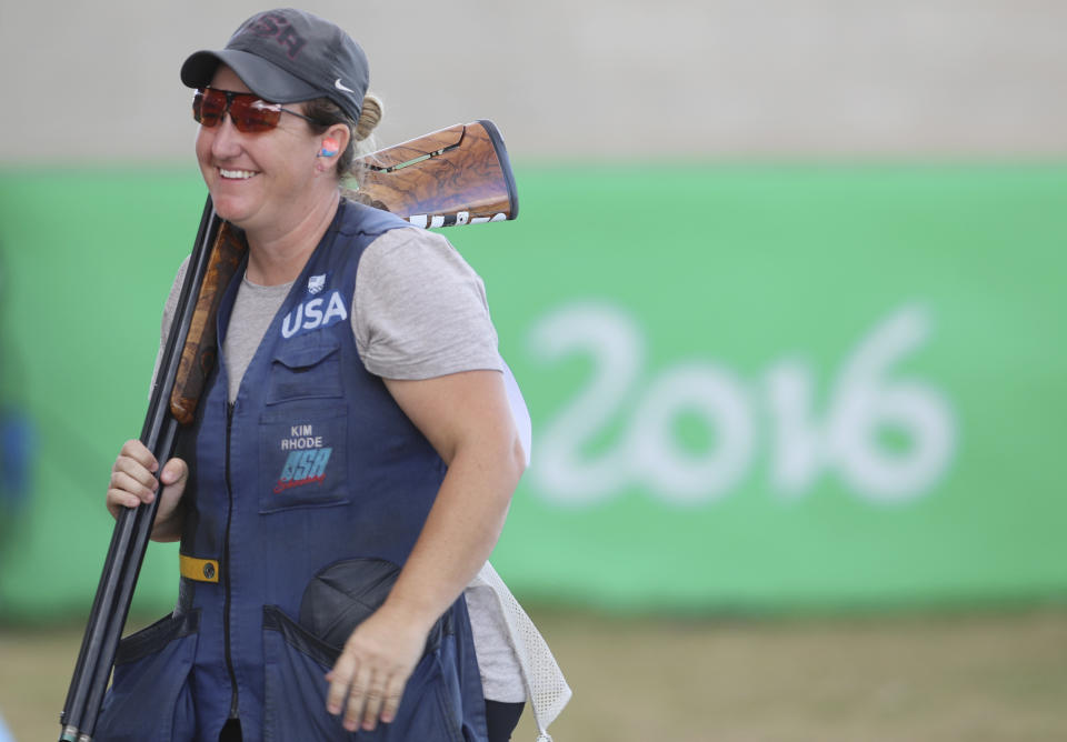 FILE -- In this Aug. 12, 2016 file photo Kimberly Rhode of the United States smiles after she won the bronze medal match of the women's skeet event at Olympic Shooting Center at the 2016 Summer Olympics in Rio de Janeiro, Brazil. Rhode, who has medaled in six straight Olympic Games, is the star plaintiff in a lawsuit to stop a 2016 voter-approved ballot initiative requiring background checks for the purchase of ammunition that is to take effect July 1. (AP Photo/Eugene Hoshiko, File)