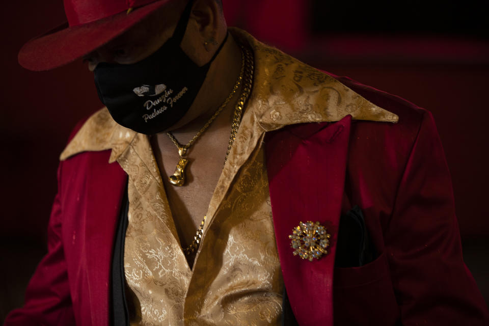 Ricardo Zamorano wears a hat and zoot suit during an event to raise money and keep open the iconic dance hall known as “The Cathedral of Mambo” amid the new coronavirus pandemic in Mexico City, Saturday, Sept. 5, 2020. Millionaires, writers, ambassadors, and movie stars danced here; now, shuttered for more than five months due to the pandemic, the owners of the fabled hall say they are in debt and may have to close and demolish it. (AP Photo/Fernando Llano)