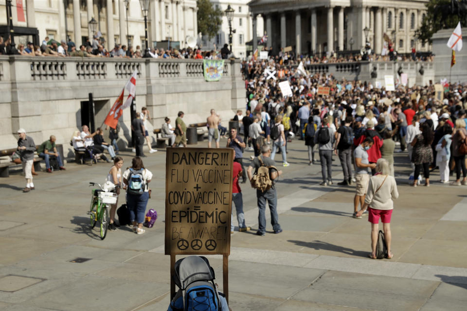 People take part in a "Resist and Act for Freedom" protest against a mandatory coronavirus vaccine, wearing masks, social distancing and a second lockdown, in Trafalgar Square, London, Saturday, Sept. 19, 2020. (AP Photo/Matt Dunham)