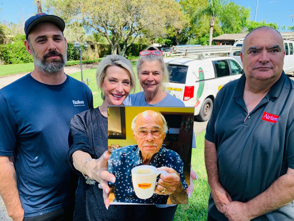 Caroline Busto holds a photo of her late father A.C. "Bud" Goodier, the founder of A.C. Goodier Air Conditioning & Refrigeration, who died on March 5, 2022, at age 86. Also pictured are Goodier's other daughter, Cindy Tanner, and longtime employees Ben Cubbedge, right, and his son Ben Cubbedge Jr.