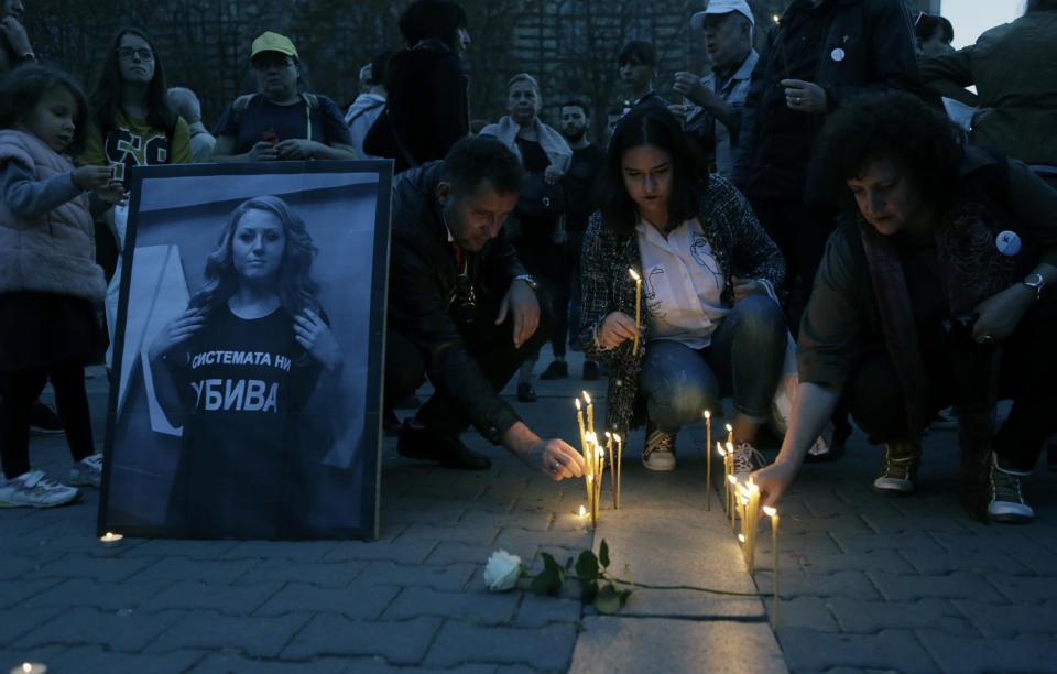 A portrait of the Bulgarian journalist Viktoria Marinova, killed in the northern town of Ruse, is seen during a vigil in Sofia, Monday, Oct. 8, 2018. Bulgarian police are investigating the rape, beating and slaying of a female television reporter whose body was dumped near the Danube River after she reported on the possible misuse of European Union funds in Bulgaria. (AP Photo/Valentina Petrova)