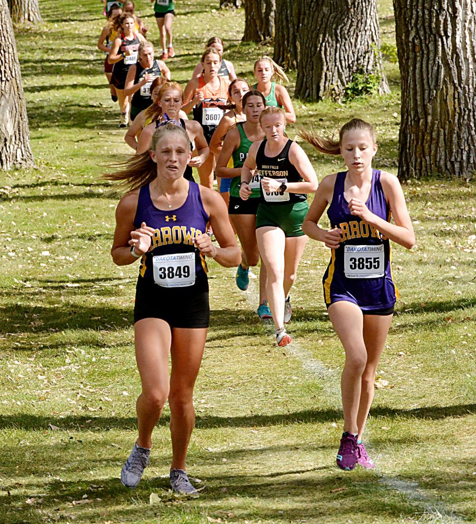 Watertown's Isabella Horning (left) and Grace List run in the varsity boys' 5,000-meter race Thursday, Sept. 29, 2022 during the Watoma Invitational cross country meet at Cattail Crossing Golf Course.