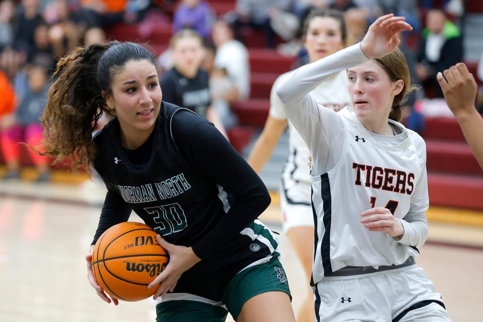 Norman North's Seleh Harmon gathers the ball beside Norman Norman'sMcKinzi Maddocks during a girls high school basketball game between Norman and Norman North at Putnam City North in Oklahoma City, Okla., Tuesday, Feb. 20, 2024.