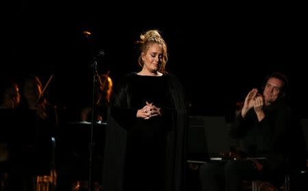 Singer Adele is applauded as he finishes her tribute to the late George Michael at the 59th Annual Grammy Awards in Los Angeles, California, U.S. , February 12, 2017. REUTERS/Lucy Nicholson