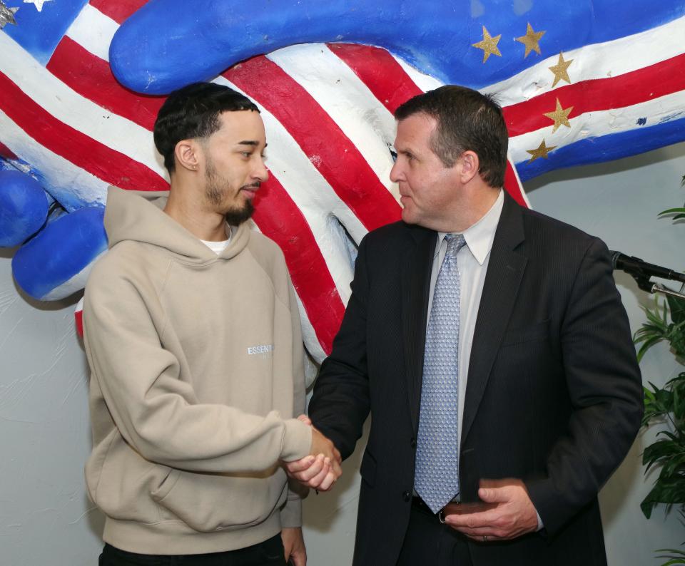 Nicalas Fernandes, of Brockton, is congratulated by Brockton Mayor Robert Sullivan after Fernandes signed his Olympic Scholarship contract at the Brockton Cape Verdean Association on Monday, April 11, 2022. Fernandes has hopes of participating in the 2024 Summer Olympics taekwondo competition in Paris.