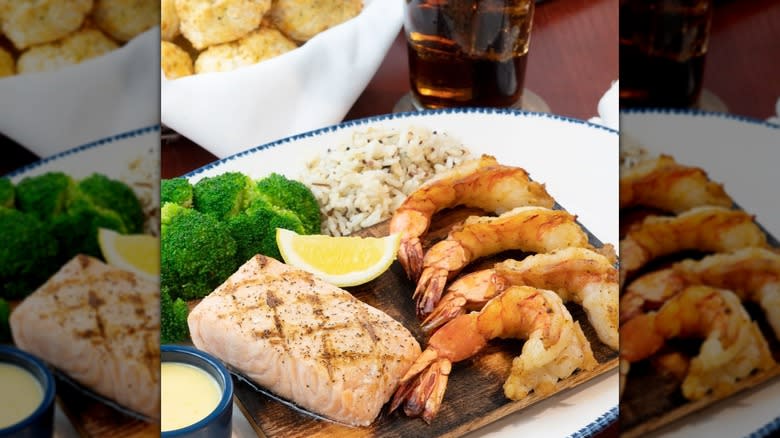 Wooden platter with seafood, rice, and broccoli