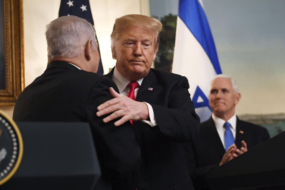 FILE - In this March 25, 2019, file photo, President Donald Trump embraces Israeli Prime Minister Benjamin Netanyahu, as Vice President Mike Pence looks on, in the Diplomatic Reception Room of the White House in Washington. Netanyahu routinely boasts that Trump is the best friend that Israel has ever had in the White House. But things have begun to change since he failed to win reelection in April and was forced to hold a second, inconclusive vote last month. (AP Photo/Susan Walsh, File)