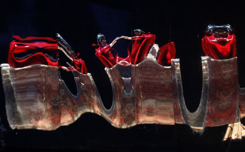 In this Feb. 24, 2012 photo, is the reflective form of the evil Queen of Damascus, Armida, played by Elza Van Den Heever, during the final dress rehearsal at the Lyric Opera of Chicago's production of Rinaldo. (AP Photo/Charles Rex Arbogast)