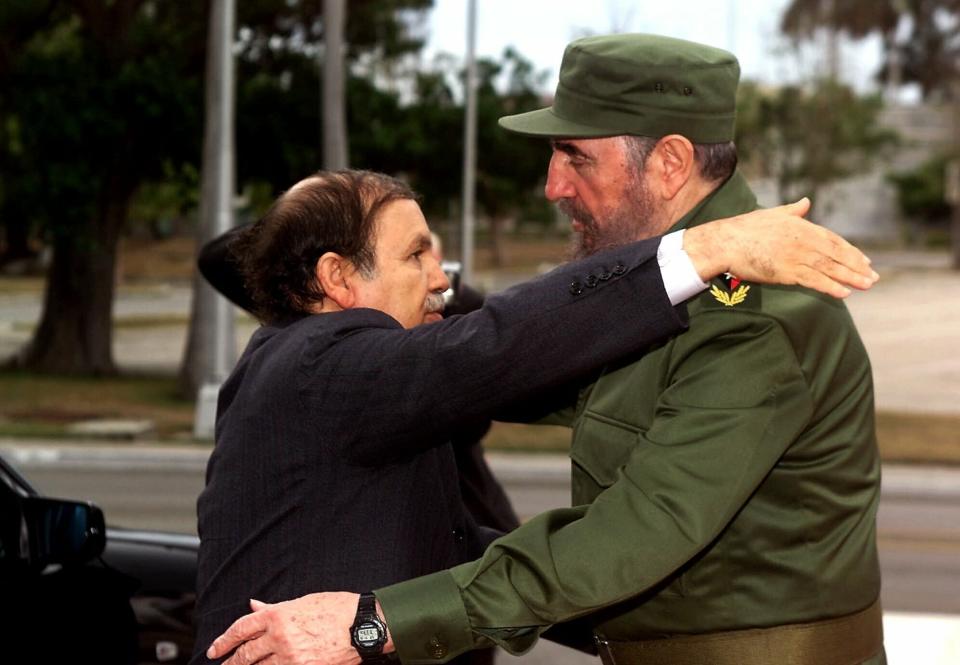 FILE - In this April 15 2000 file photo, Cuban President Fidel Castro, right, embraces Algerian President Abdelaziz Bouteflika starting an official visit to Cuba. Former Algerian President Bouteflika, who fought for independence from France in the 1950s and 1960s and was ousted amid pro-democracy protests in 2019 after 20 years in power, has died at age 84, state television announced Friday, Sept. 17, 2021. (AP Photo/Jose Goitia, File)