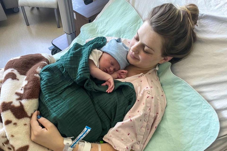 <p>Courtesy Kim Savage</p> Kenzie Lewellen holding her son, Dewey Lester Bennett IV