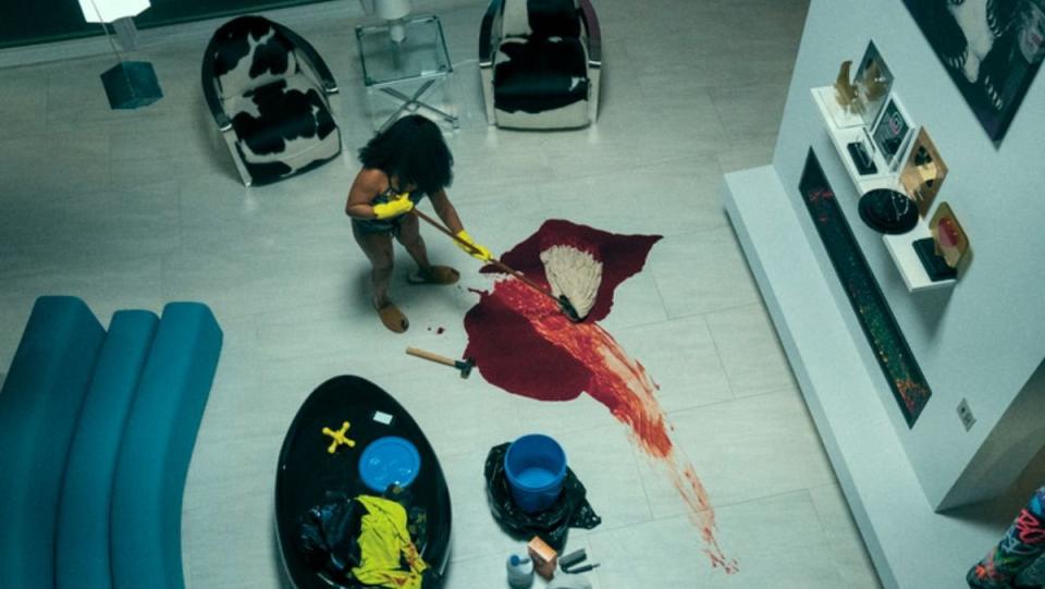 a woman in a nice house with marble floors mops up blood in swarm teaser trailer