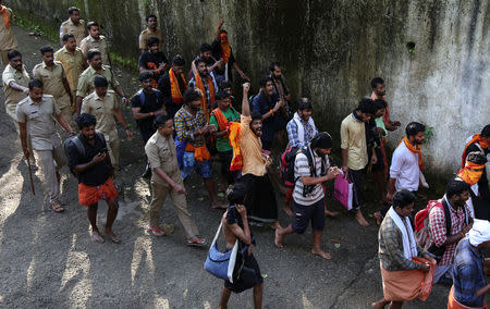 Policemen escort members of the Hindu groups to Pampa base camp, to prevent them from clashing with women entering Sabarimala temple, in Pathanamthitta district in the southern state of Kerala, India, October 18, 2018. REUTERS/Sivaram V