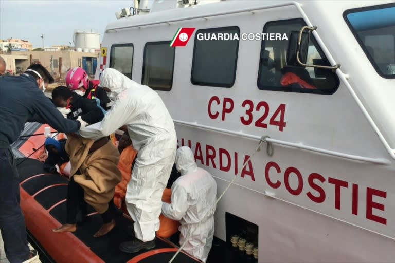 Migrants arrive at Lampedusa harbour after a rescue operation at sea off the coast of Libya, in a video capture released by the Italian Coast Guard on April 30, 2016