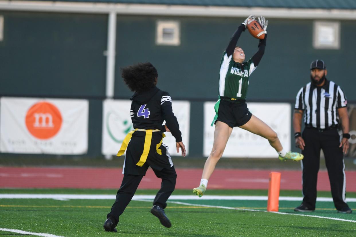 Greenbrier's Maggie Pangle (1) jumps for the ball during the Greenbrier and Miller Grove flag football playoff game at Greenbrier High School on Tuesday, Dec. 5, 2023. Greenbrier defeated Miller Grove 39-0.