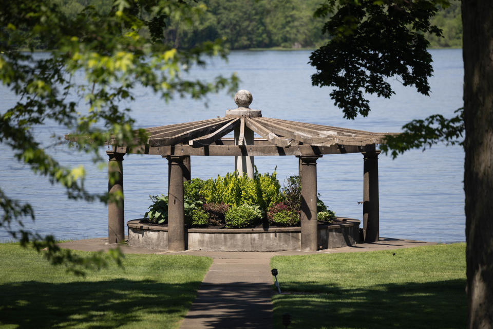 A garden pergola sits on the waters edge of Chippewa Lake at The Oaks Lakeside Restaurant in Chippewa Falls, OH.