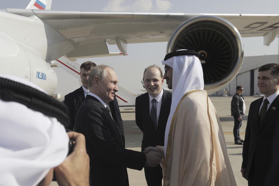 United Arab Emirates Foreign Minister Abdullah bin Zayed Al Nahyan, right, greets Russian President Vladimir Putin upon his arrival at an international airport in Abu Dhabi, United Arab Emirates, Wednesday, Dec. 6, 2023. (Andrei Gordeyev, Sputnik, Kremlin Pool Photo via AP)