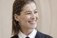 Rosamund Pike smiles before the presentation of the Dior Spring-Summer 2022 Haute Couture fashion collection, in Paris, Monday, Jan. 24, 2022. (AP Photo/Lewis Joly)