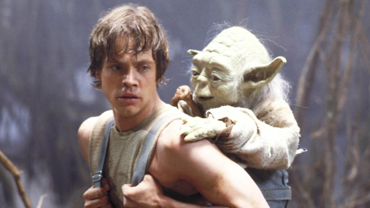  Best movies on Disney Plus: Mark Hamill as Luke Skywalker carrying Yoda on his back in Star Wars. 