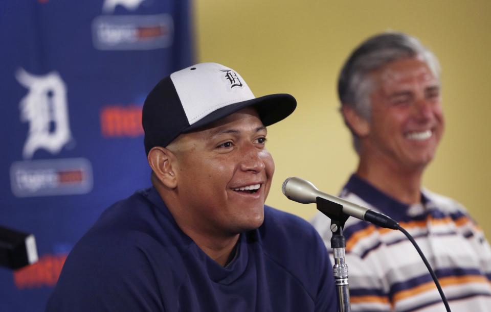 Detroit Tigers first baseman Miguel Cabrera shares a laugh with Tigers President, CEO and General Manager David Dombrowski during a news conference where the details of Cabrera's eight-year contract extension was officially announced in Lakeland, Fla., Friday, March 28, 2014. (AP Photo/Carlos Osorio)