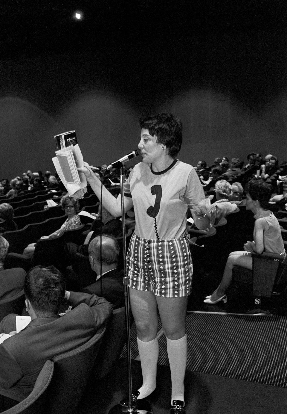 FILE - In this May 11, 1971 file photo, Evelyn Y. Davis wears hotpants as she speaks at the annual stockholders meeting of the Communications Satellite Corp. in Washington. For decades, Davis, who has been buying a few shares of big companies, attends their annual meetings, turning them into her personal stage. But in 2012, Davis didn't show up at any company's annual meeting. Age has finally made her do what the most powerful CEOs in America couldn't: Give it a rest. "I'm not so young anymore," said Mrs. Davis, 82. (AP Photo)