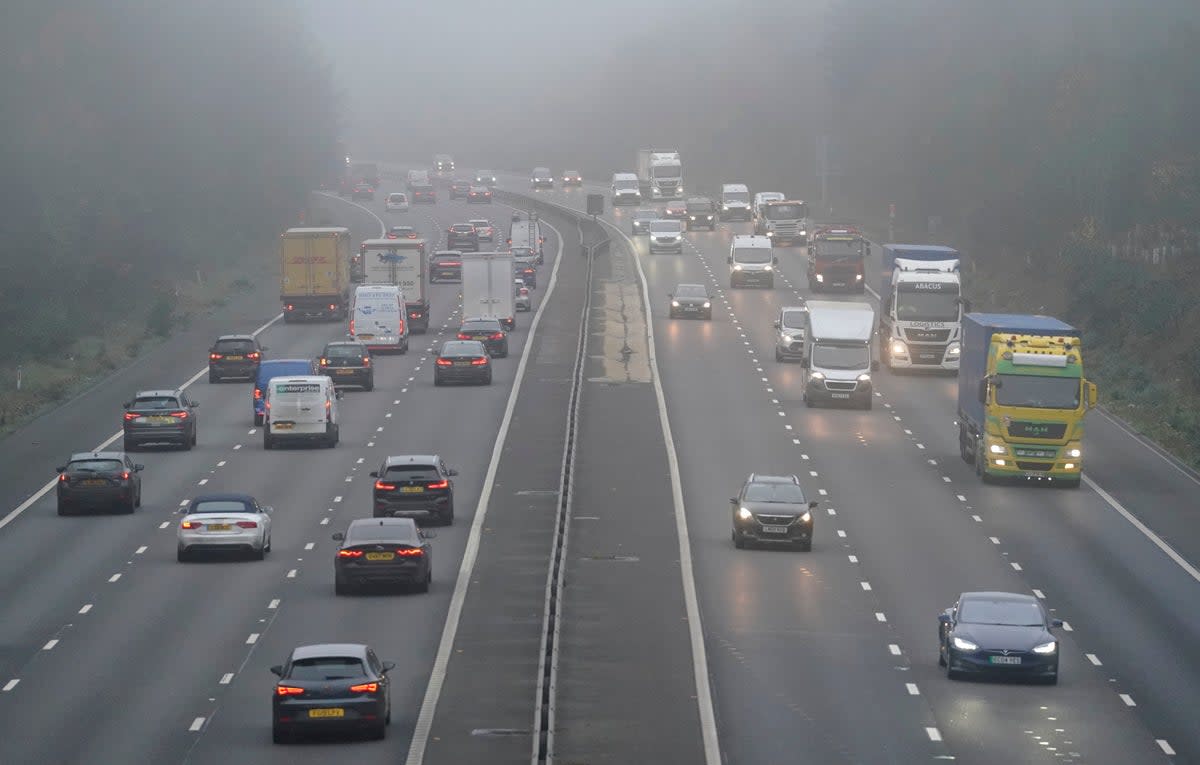 Vehicles drive through fog on the M3 near Old Basing in Hampshire on Friday (PA)