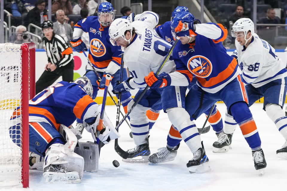 New York Islanders goaltender Ilya Sorokin (30) and Ryan Pulock (6) protect their net from Toronto Maple Leafs' John Tavares (91) during the first period of an NHL hockey game Tuesday, March 21, 2023, in Elmont, N.Y. (AP Photo/Frank Franklin II)