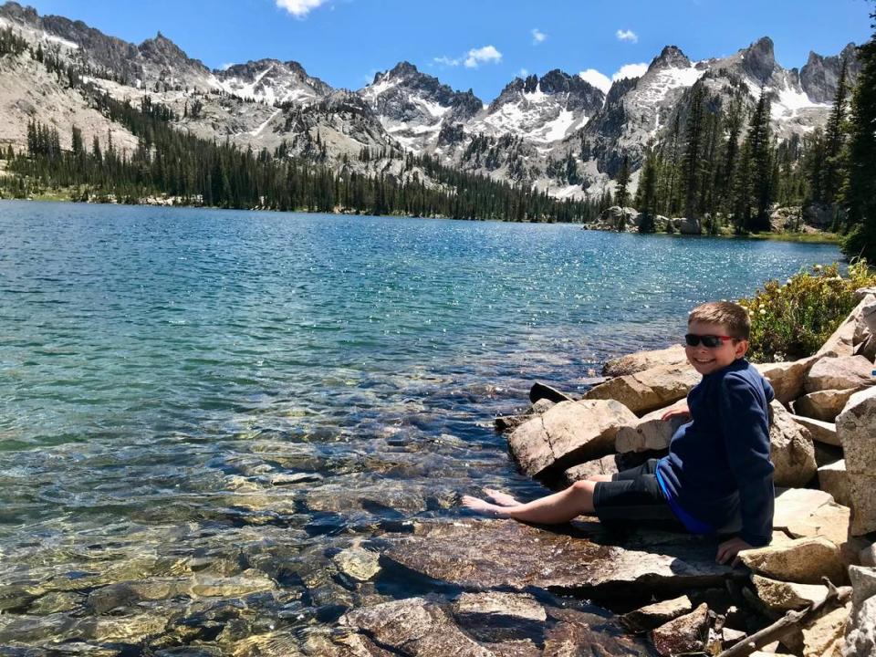 Oliver Cripe dips his feet in Alice Lake during a hike in the Sawtooth National Recreation Area in 2019. Chadd Cripe/Idaho Statesman