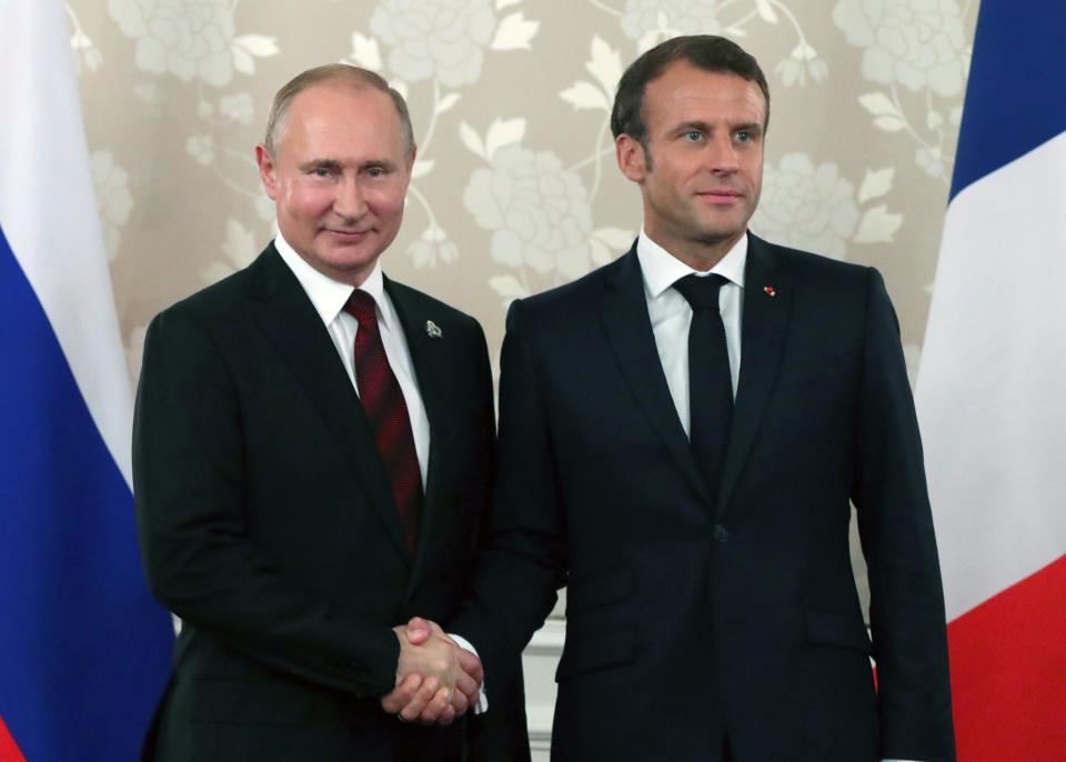 FILE - In this file photo dated Friday, June 28, 2019, French President Emmanuel Macron, right, and Russian President Vladimir Putin pose for a photo during a meeting on the sidelines of the G-20 summit in Osaka, Japan. Macron has invited Putin to his summer residency on the French Riviera, Monday afternoon Aug. 19, 2019, for talks and dinner, in an effort to improve Moscow’s relations with the European Union. (Mikhail Klimentyev, Sputnik, Kremlin FILE Pool Photo via AP)
